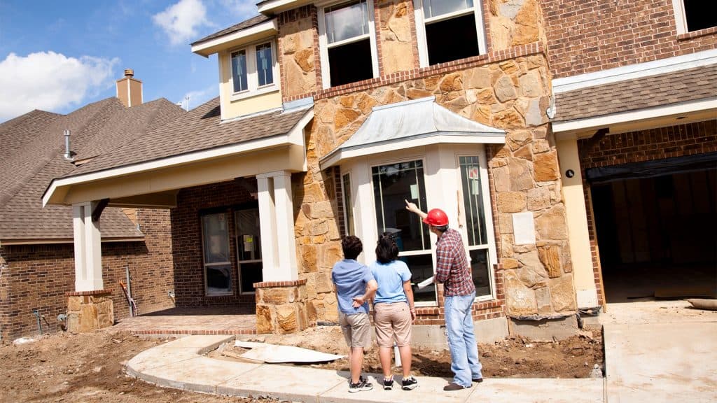 Home Inspector Inspecting Home with buyer